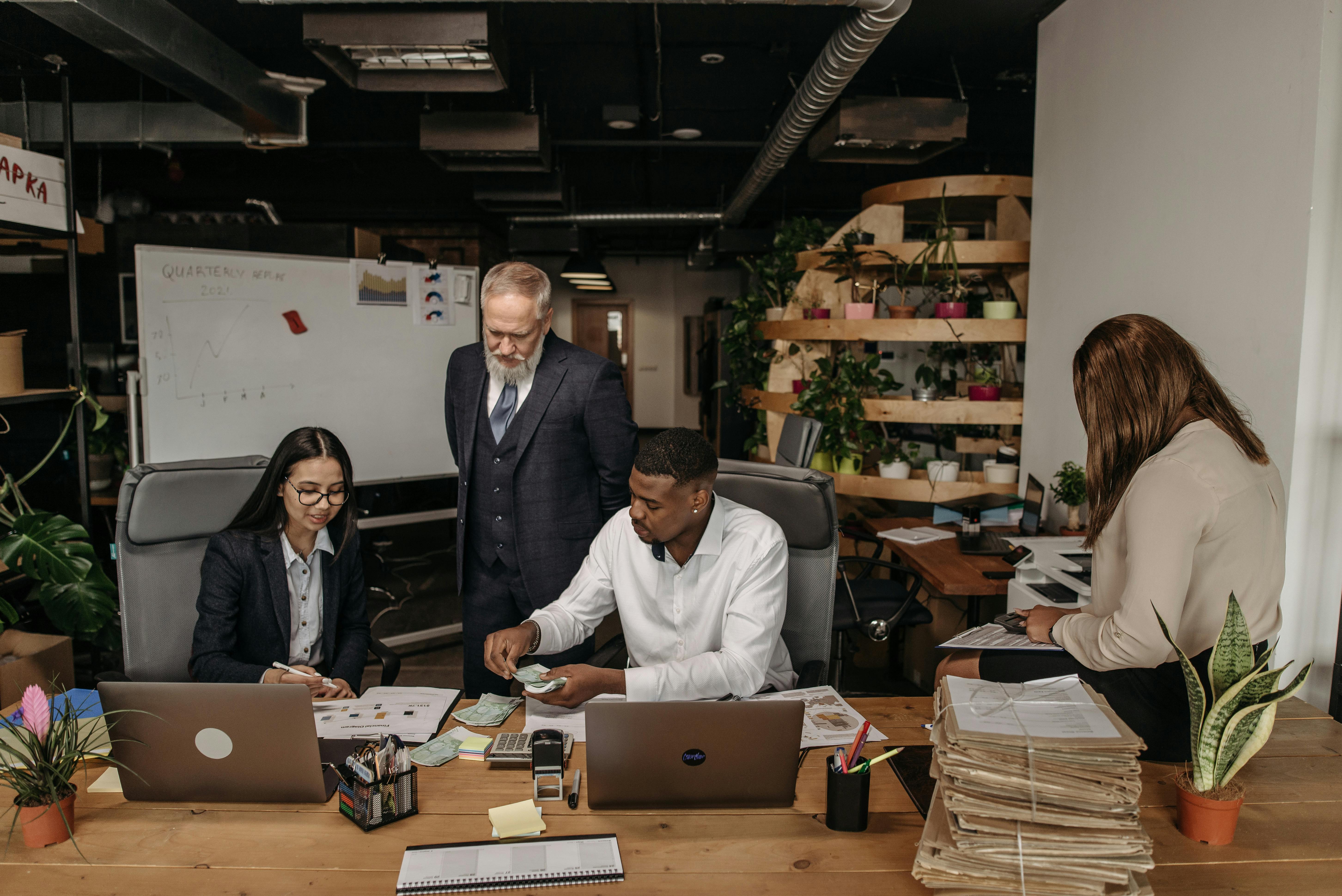 Advisory team reviewing financial reports in a modern office